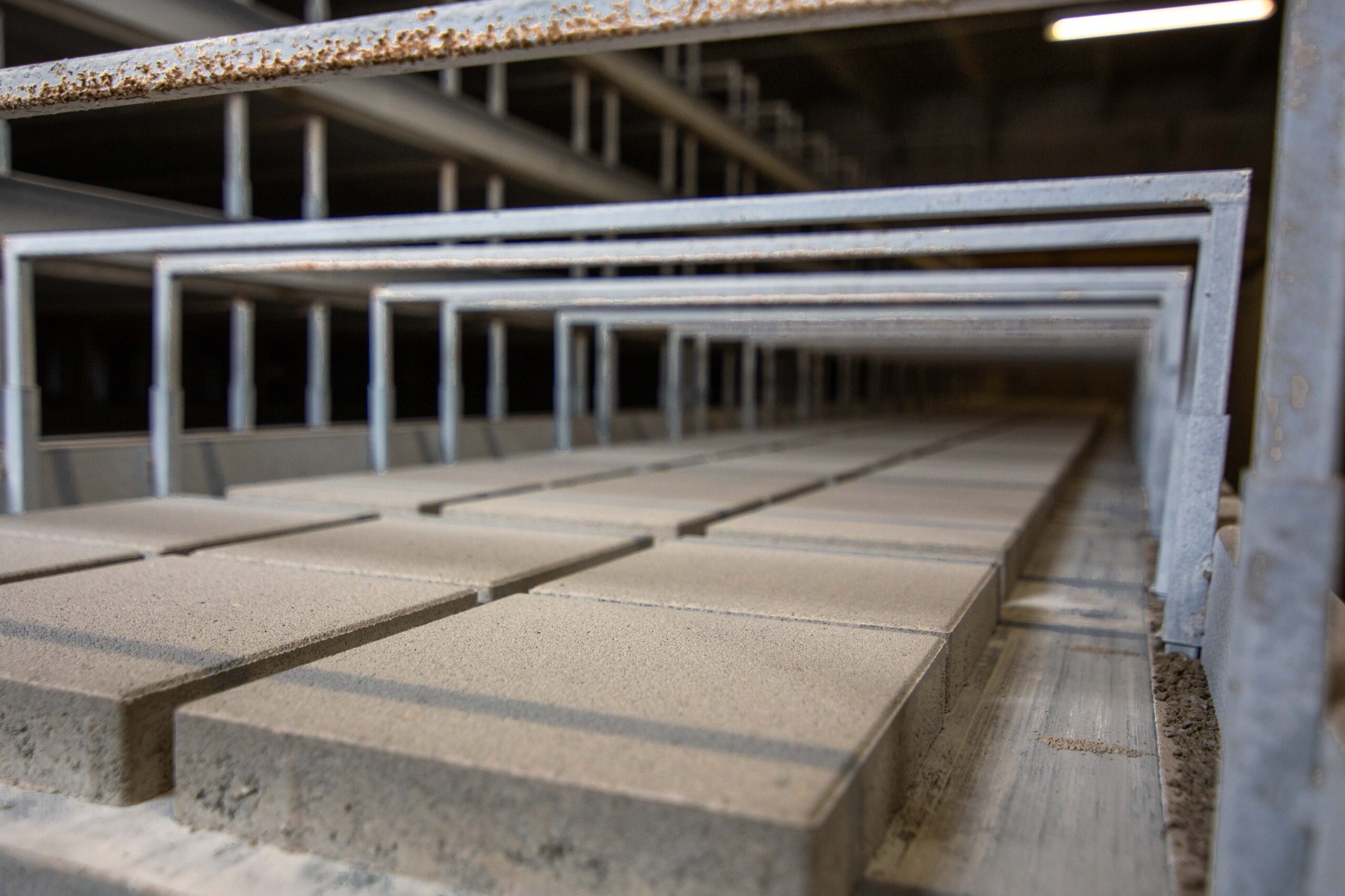 Dry cast precast concrete pavement slabs in production.